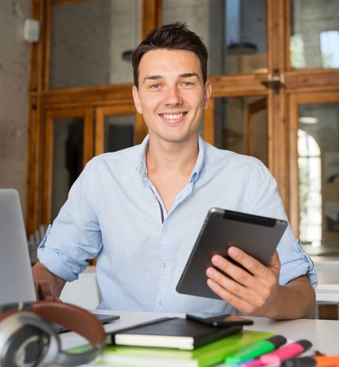 happy-young-confident-man-working-on-laptop-2023-11-27-04-58-31-utc